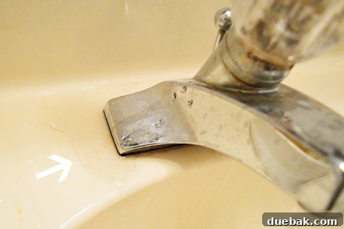 DIY Bathroom Faucet Replacement 3 Close-up of the old faucet's single knob design