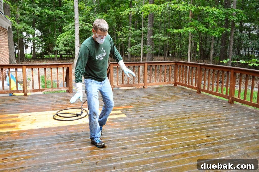 A person carefully tip-toeing on a wet deck surface covered in chemical stripper, highlighting its slipperiness