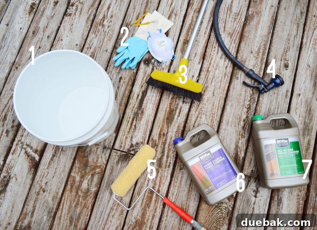 Collection of materials and supplies needed for stripping an old finish from a wood deck, including brushes, rollers, buckets, and chemicals