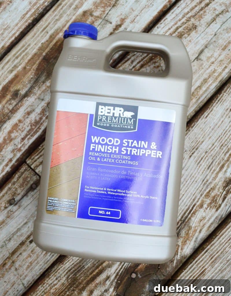 Close-up of a bottle of Behr Wood Stain And Finish Stripper, highlighting the product for deck restoration