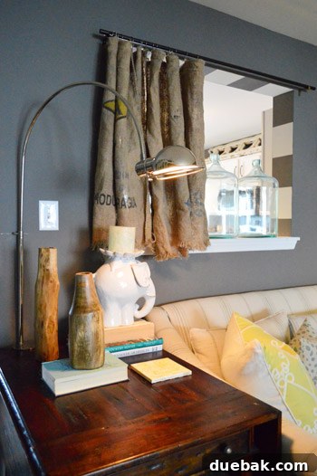 Townhouse Takeover: Unleashing Cozy Creativity 11 Kitchen pass-through with custom wide stripes and unique burlap curtains made from repurposed grain sacks.