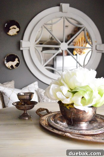 Townhouse Takeover: Unleashing Cozy Creativity 14 Detailed shot of a magnificent large white mirror, sourced from an auction, enhancing the kitchen banquette.