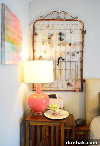 Townhouse Takeover: Unleashing Cozy Creativity 17 Master bedroom with an oversized coral-pink lamp and stunning DIY resin art made with pastel crayons.