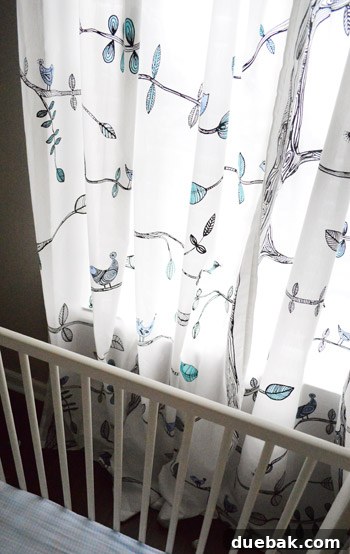 Townhouse Takeover: Unleashing Cozy Creativity 19 Close-up of nursery curtains, featuring a unique watercolor effect achieved by coloring inexpensive Ikea curtains with a Sharpie.