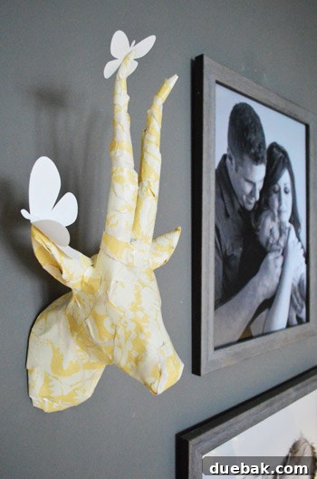 Townhouse Takeover: Unleashing Cozy Creativity 10 Paper mache deer head from Z Gallerie, customized with wallpaper scraps and topped with delicate butterflies.