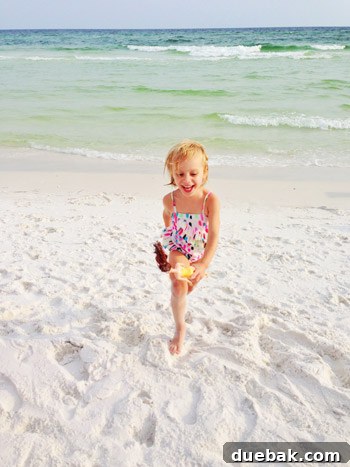 Child playing happily on the beach in Destin, Florida by the water
