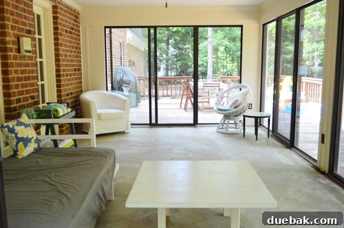 The sunroom with old carpet and base heater, envisioned as an open covered porch