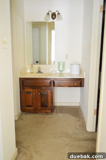 Our bathroom with glass shower door and blue hex floor tile, beginning its transformation