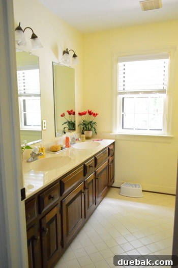 Hall bathroom with old tile and fixtures, awaiting renovation