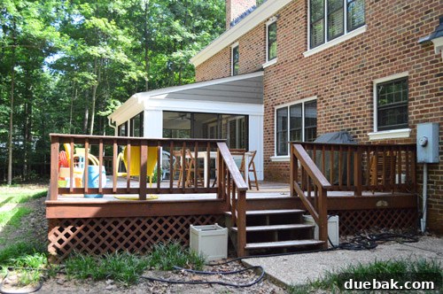 The back deck with a giant oak tree growing too close to the house, prior to tree removal