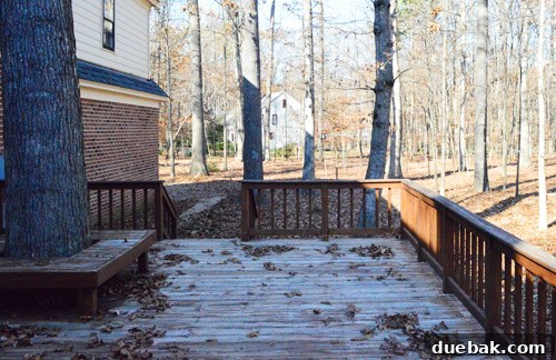 An old, weathered, and unkempt deck before any renovation work began, showing its previous state.