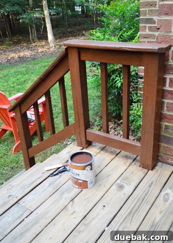 Newly stained deck railing perfectly matching the older, un-stripped sections, showcasing the success of the color choice.
