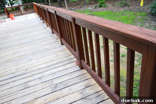 Early morning sunlight beginning to hit the stained deck railings, highlighting the need to pause work on the floor.