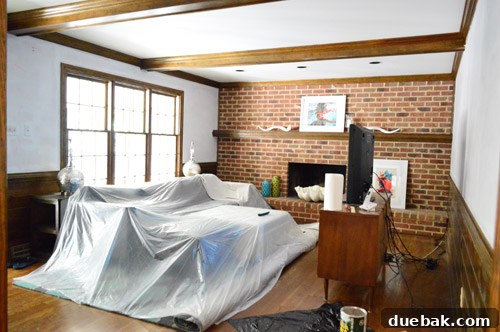 Living room walls freshly covered with primer after old paint removal