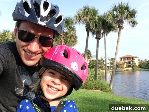 Child happily riding in an iBert bike seat with a parent in Destin, Florida