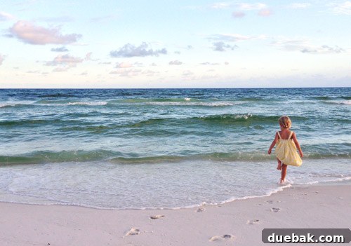 Sunset over Destin beach with family silhouettes, a beautiful ending to a vacation