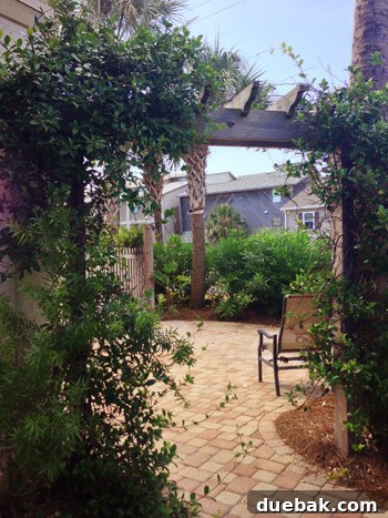 Beautiful outdoor courtyard with arbors and lush vines at a Destin vacation home