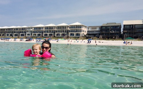 Child enjoying the warm, calm waters of Destin beach, a perfect family spot