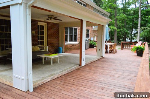 The sunroom transformed into an open veranda, offering seamless access to the surrounding deck