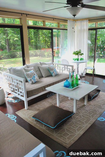 Interior view of the sunroom before renovation, showing existing furniture and floor