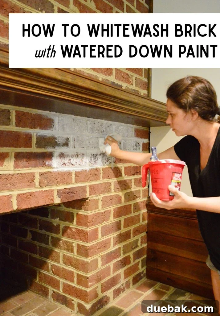 DIY Whitewashing: Transform Your Brick Fireplace 3 Sherry carefully dabbing diluted white paint onto a vibrant red brick fireplace, demonstrating the technique for a perfect whitewash effect.