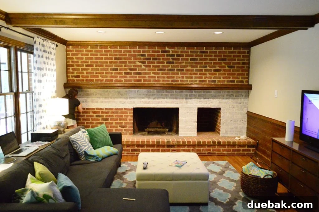DIY Whitewashing: Transform Your Brick Fireplace 7 A step-by-step visual of the whitewash brick technique being applied to a living room fireplace wall, transforming its appearance.