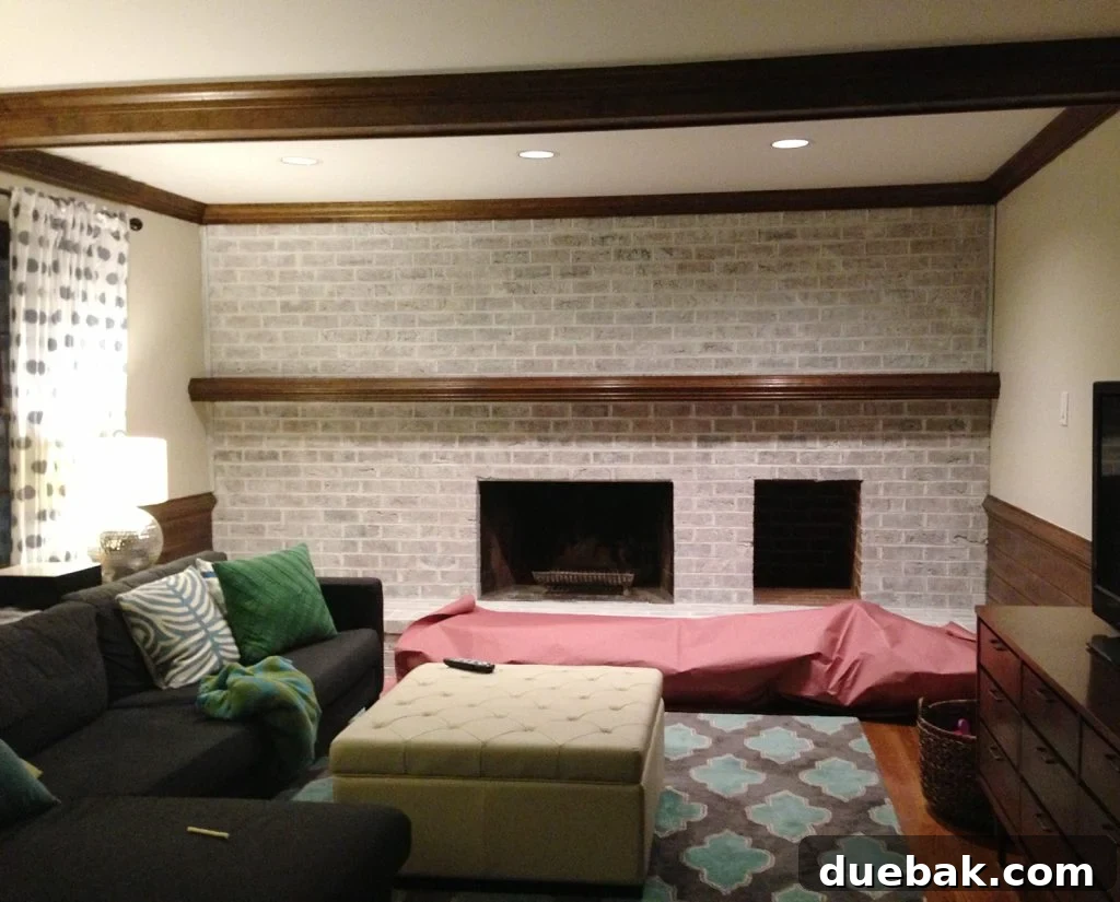 DIY Whitewashing: Transform Your Brick Fireplace 10 A lightly whitewashed brick wall in a living room, featuring a fireplace and mantle, achieved using leftover white paint for a subtle effect.