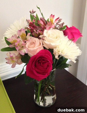 Overhead view of a mixed floral bouquet in a glass vase, showing the intricate arrangement of various blooms.