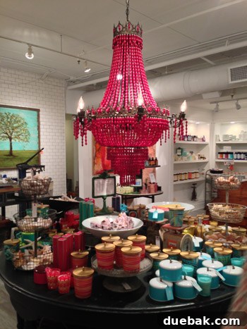 Seaside's Simple Pleasures: Window Shopping The Art of Simple 5 A striking red beaded chandelier hangs prominently, offering a luxurious and bold accent piece for home decor.