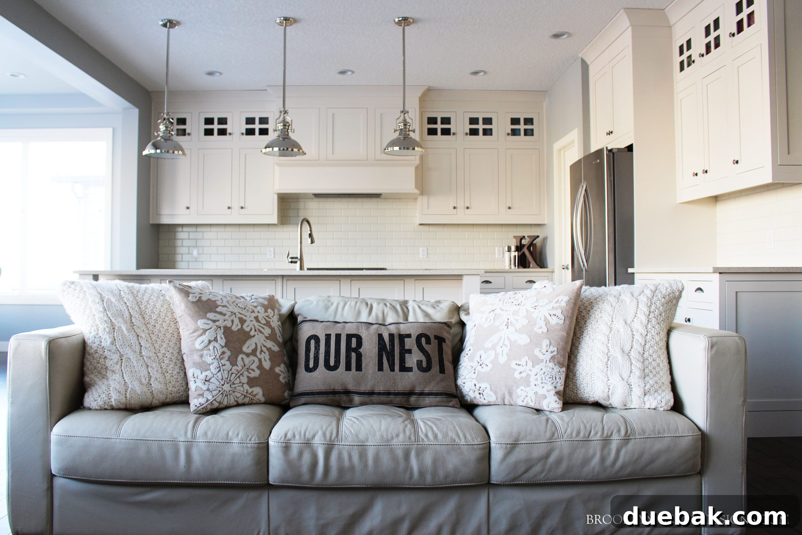 Spacious great room with large windows, comfortable seating, and a modern fireplace, ideal for family gatherings.