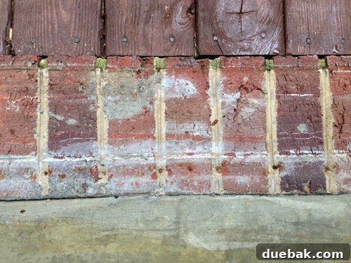 Beton Zemin İçin Boya mı Fayans mı? 8 Close-up of sunroom brick border showing glue stains, nail holes, and gouges, detailing existing damage