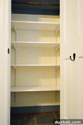 From Coat Closet To Toy Central 8 Wooden shelves cut to size and placed on the adjustable brackets, completing the shelving installation.