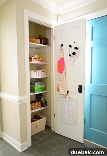 From Coat Closet To Toy Central 10 Closet interior after painting, with the adjustable shelves now holding organized baskets of toys.