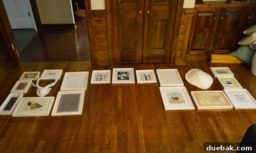 Gallery wall layout planned on the floor