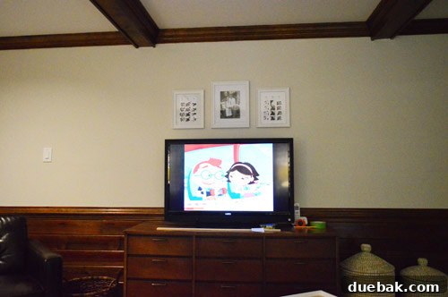 First frame being hung, centered on the TV's future spot