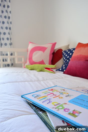 A close-up shot focusing on a children's book, with a blurred alligator toy in the foreground.