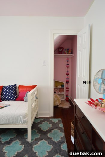 Clara's closet interior showing the subtle pink ceiling and white walls, with potential for future built-ins.