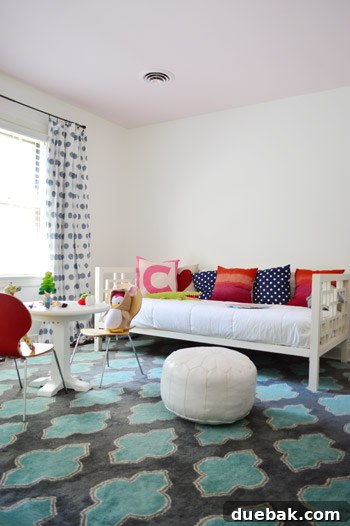 A wide shot of Clara's room, showing the painted walls and ceiling, as well as the relocated blue rug and curtains.