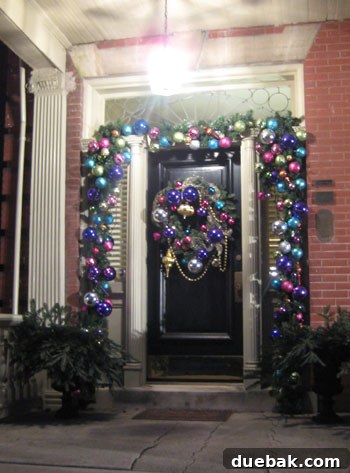 Mardi Gras Christmas Decor Richmond A front door in Richmond with holiday decor blending traditional elements with subtle Mardi Gras beads for a sophisticated look.