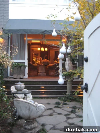 Richmond Designer Patio Sunroom Decor A stylish back patio with gourd decorations and a canopied sunroom with beach-themed decor in Richmond's Fan District.