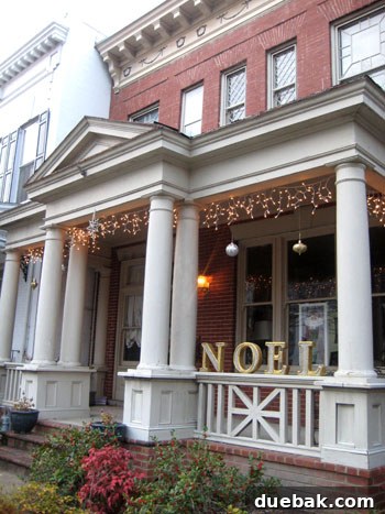 Gilded Holiday Greeting Letters A charming home with a holiday greeting spelled out in gilded block letters adhered to the facade.