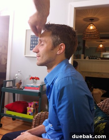 John getting makeup applied for the shoot, a humorous behind-the-scenes moment