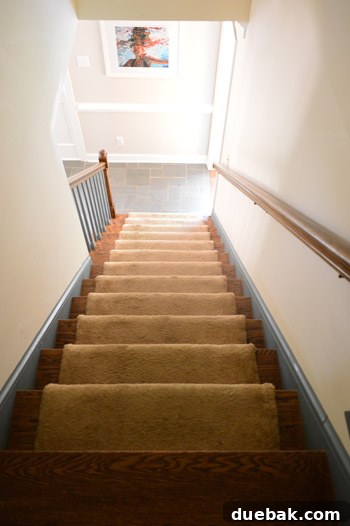 Transform Your Staircase with White Painted Balusters 6 Bottom section of staircase with blue balusters and baseboard