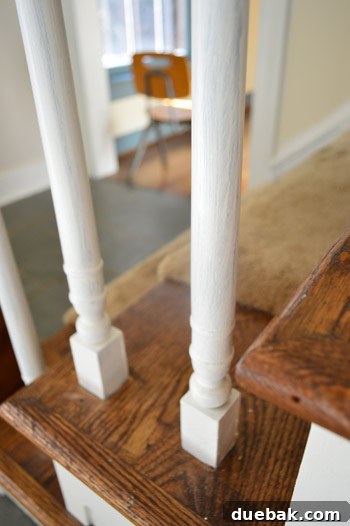 Transform Your Staircase with White Painted Balusters 9 Staircase balusters after one coat of white paint, with blue showing through