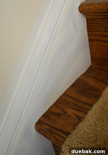 Transform Your Staircase with White Painted Balusters 10 Staircase balusters after two coats of white paint, still showing faint blue
