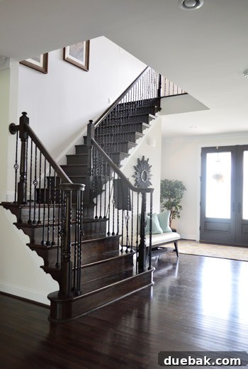 Dramatic dark staircase in a high-contrast black and white themed home
