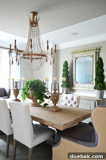 Ornate rustic dining room with a beaded chandelier and large cozy chairs