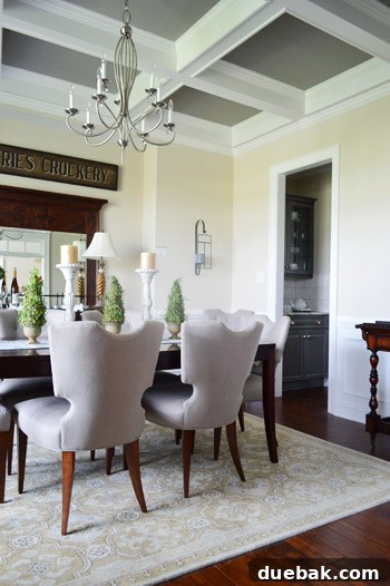 Dining room with a dark coffered ceiling and elegant furnishings