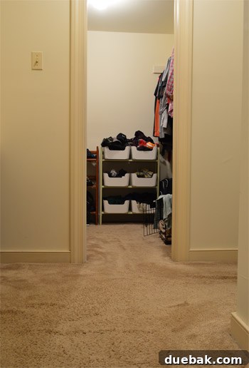 Close-up of the old, worn cream-colored carpet in the bathroom