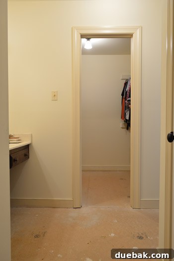 Exposed particle board subfloor after carpet removal, awaiting new flooring